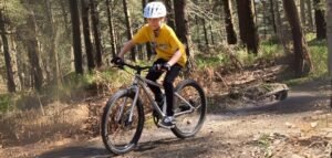 7-year-old boy practicing bike control on a beginner off-road trail in the Surrey Hills
