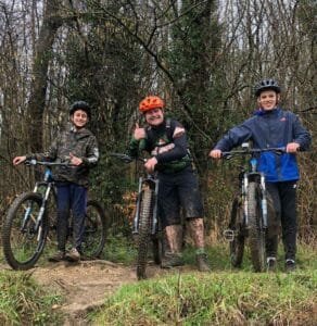 Excited young riders smiling during a Marmalade MTB off-road taster session