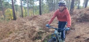 Teenagers (11-14 years) enjoying a guided mountain bike ride through the Surrey Hills woodland