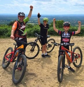 Excited young riders smiling during a Marmalade MTB off-road taster session