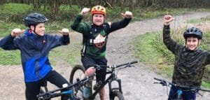 Excited young riders smiling during a Marmalade MTB off-road taster session