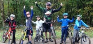 Excited young riders smiling during a Marmalade MTB off-road taster session