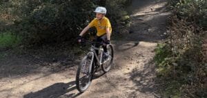 7-year-old boy practicing bike control on a beginner off-road trail in the Surrey Hills