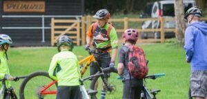 Happy child on a mountain bike, smiling as they cycle through nature, highlighting the fun and outdoor adventure of the sport