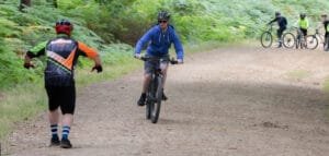 Happy child on a mountain bike, smiling as they cycle through nature, highlighting the fun and outdoor adventure of the sport
