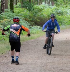 Happy child on a mountain bike, smiling as they cycle through nature, highlighting the fun and outdoor adventure of the sport