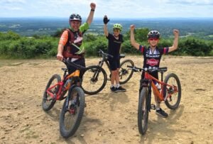 Happy child on a mountain bike, smiling as they cycle through nature, highlighting the fun and outdoor adventure of the sport