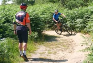 Happy child on a mountain bike, smiling as they cycle through nature, highlighting the fun and outdoor adventure of the sport