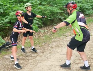 Happy child on a mountain bike, smiling as they cycle through nature, highlighting the fun and outdoor adventure of the sport