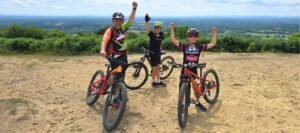Happy child on a mountain bike, smiling as they cycle through nature, highlighting the fun and outdoor adventure of the sport